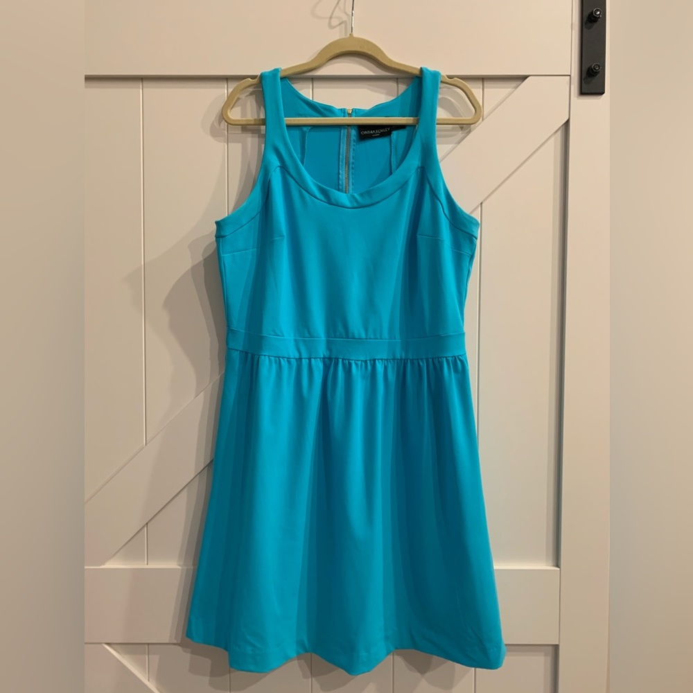 Cynthia Rowley teal 85% nylon and 15% spandex racerback dress with pockets.